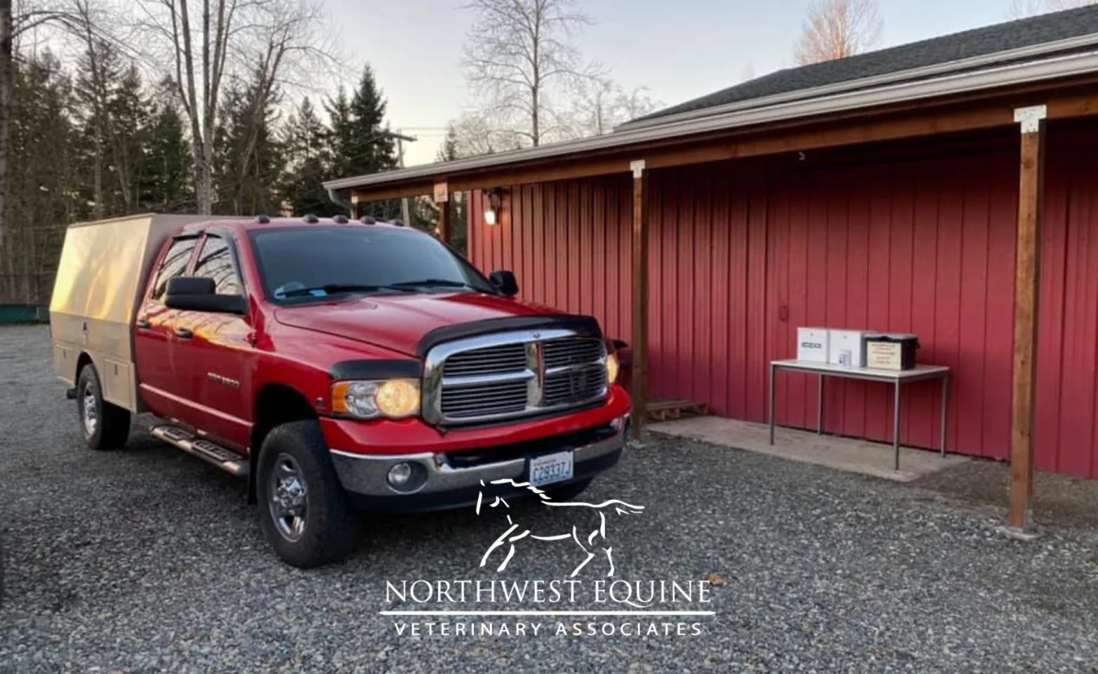 Red barn and big white SUV for mobile equine care at Northwest Equine Veterinary Associates